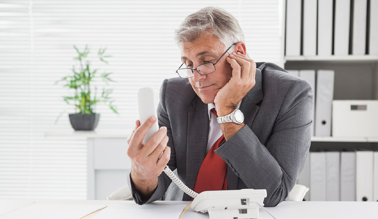 Smiling businessman put on hold